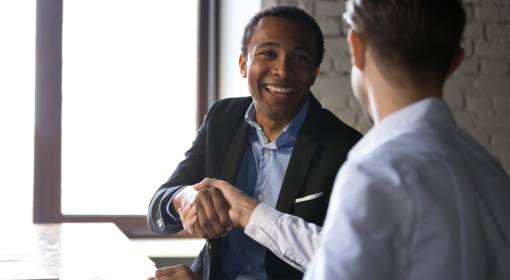 Satisfied client shaking hands thanking manager for good deal